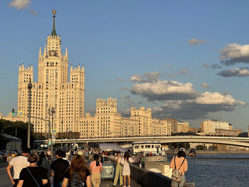 Group of people in front of buildings against sky