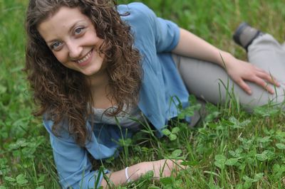 Portrait of happy woman sitting on grass