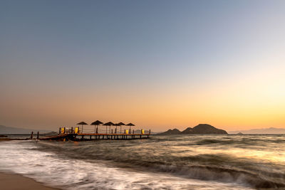 Scenic view of sea against clear sky during sunset