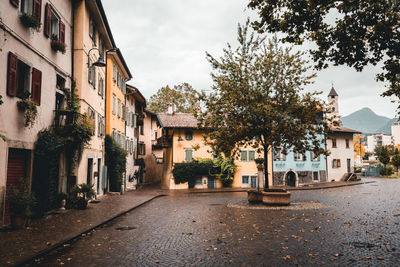 Street amidst buildings in town against sky