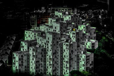 Low angle view of illuminated buildings in city at night