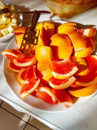 High angle view of chopped fruits in plate on table