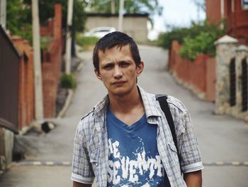 Portrait of young man standing outdoors