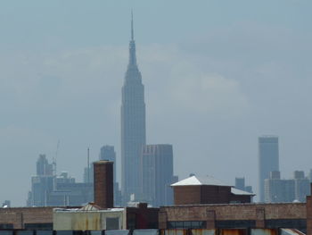 Skyscrapers in city against sky