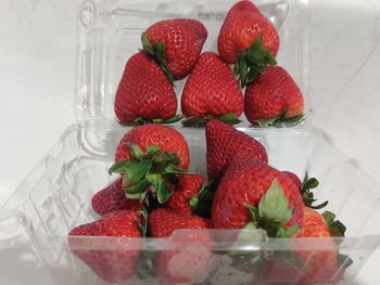 Close-up of strawberries in glass container on table