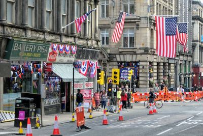 Group of people walking on road in city