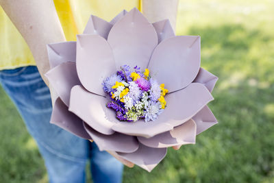 Midsection of woman with flowers