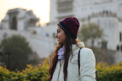 Portrait of young woman looking away outdoors