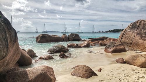 Rocks on beach against sky