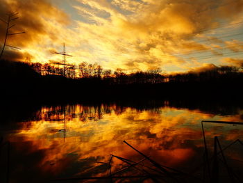Scenic view of lake against orange sky