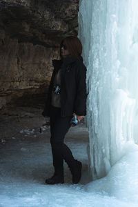  woman standing near ice wall 