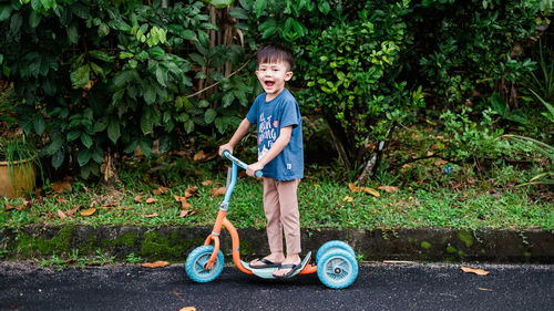 Portrait of smiling boy standing against plants