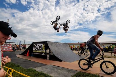 People riding bicycle against sky