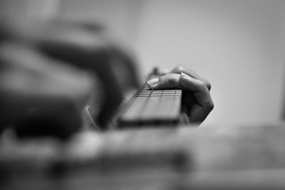 Close-up of hand playing guitar