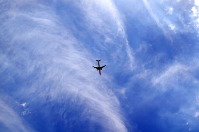 Low angle view of airplane flying in sky