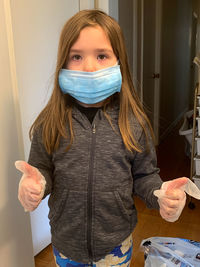 Portrait of a teenage girl standing at home