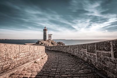 View of lighthouse against cloudy sky