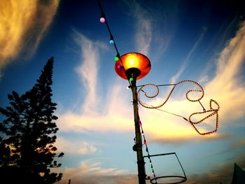 Low angle view of street light against cloudy sky