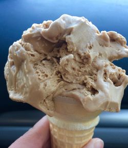 Close-up of hand holding ice cream cone