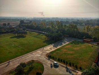 High angle view of road amidst field against sky