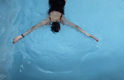 Young woman swimming in pool