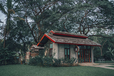 House in park against trees in forest