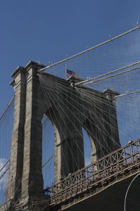 Low angle view of suspension bridge against sky