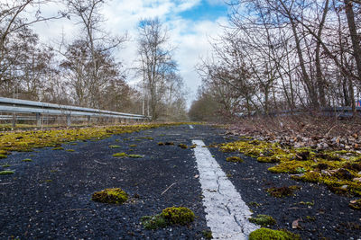 Empty road against cloudy sky