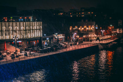 Illuminated city against sky at night