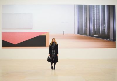 Full length of woman standing by railing