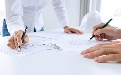 Midsection of couple holding hands on table