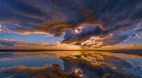 Scenic view of lake against romantic sky at sunset