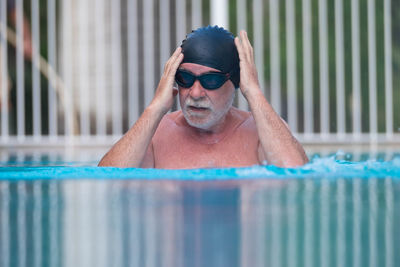 Portrait of man wearing sunglasses at swimming pool