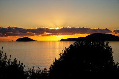 Scenic view of sea against romantic sky at sunset