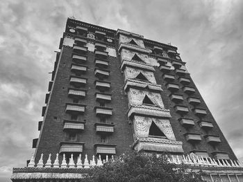 Low angle view of building against cloudy sky