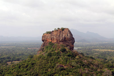 Rock formations on landscape against sky