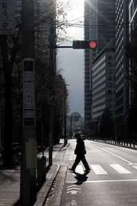 Rear view of woman walking on street in city
