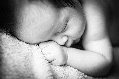 High angle view of baby girl sleeping on bed