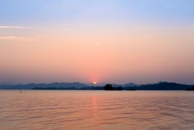 Scenic view of sea against romantic sky at sunset