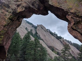 Low angle view of rocky mountains against sky