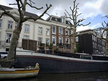 Boats in canal with buildings in background