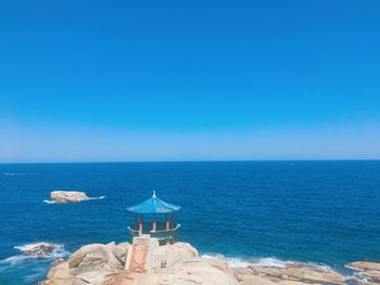 Scenic view of sea against clear blue sky