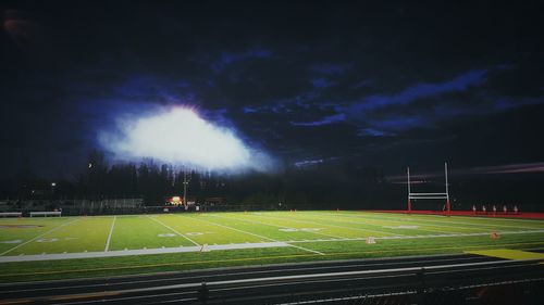 View of illuminated landscape against cloudy sky