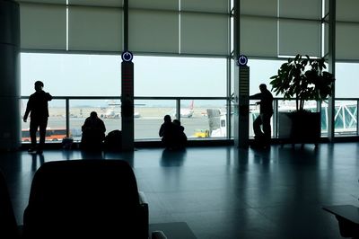 Silhouette people waiting at airport
