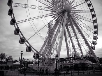 Low angle view of ferris wheel against sky