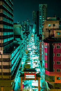 High angle view of illuminated buildings in city at night
