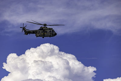 Low angle view of airplane flying against sky