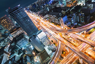 High angle view of illuminated buildings in city at night