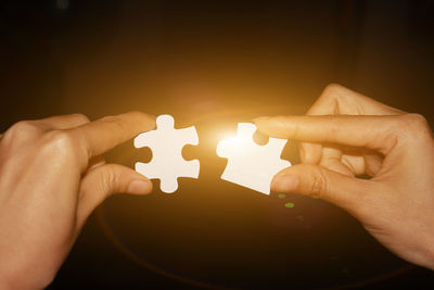 Close-up of hands holding candles