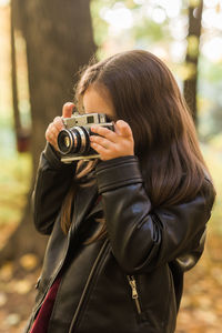 Portrait of woman photographing